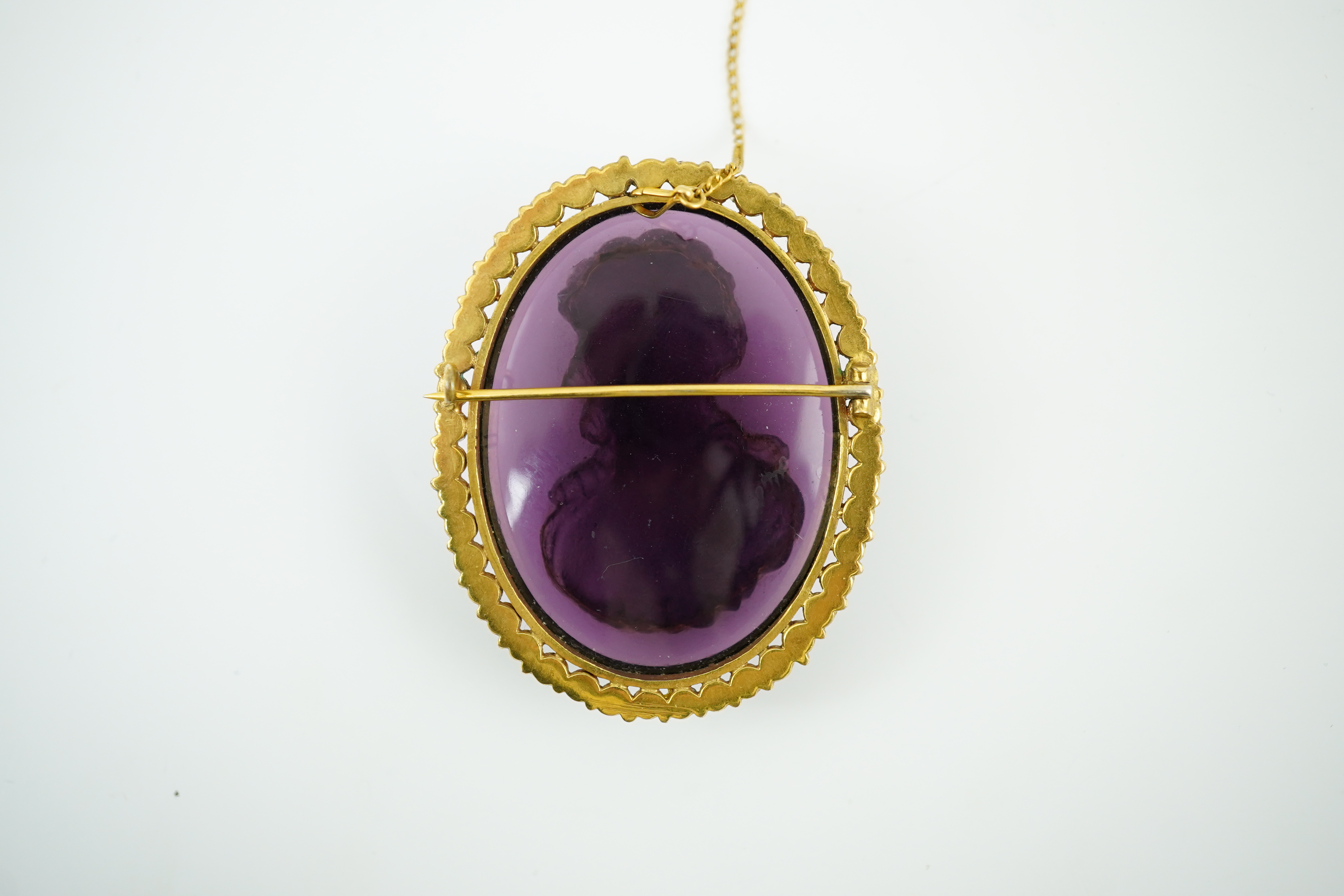 A late 19th/early 20th century gold and turquoise enamel? mounted oval amethyst paste set brooch